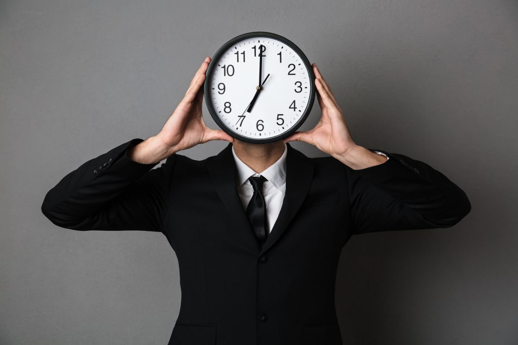 A man with a clock face, time efficiency is a part of HR outsourcing